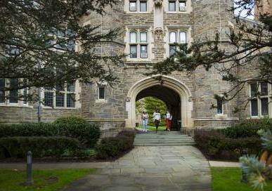 Students walking under Rock arch